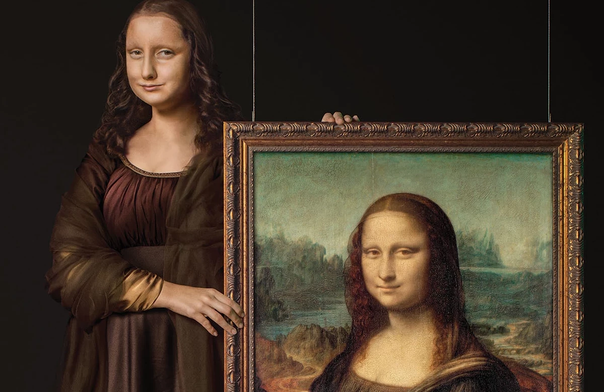 Campaign imagery of a woman holding the Mona Lisa painting up