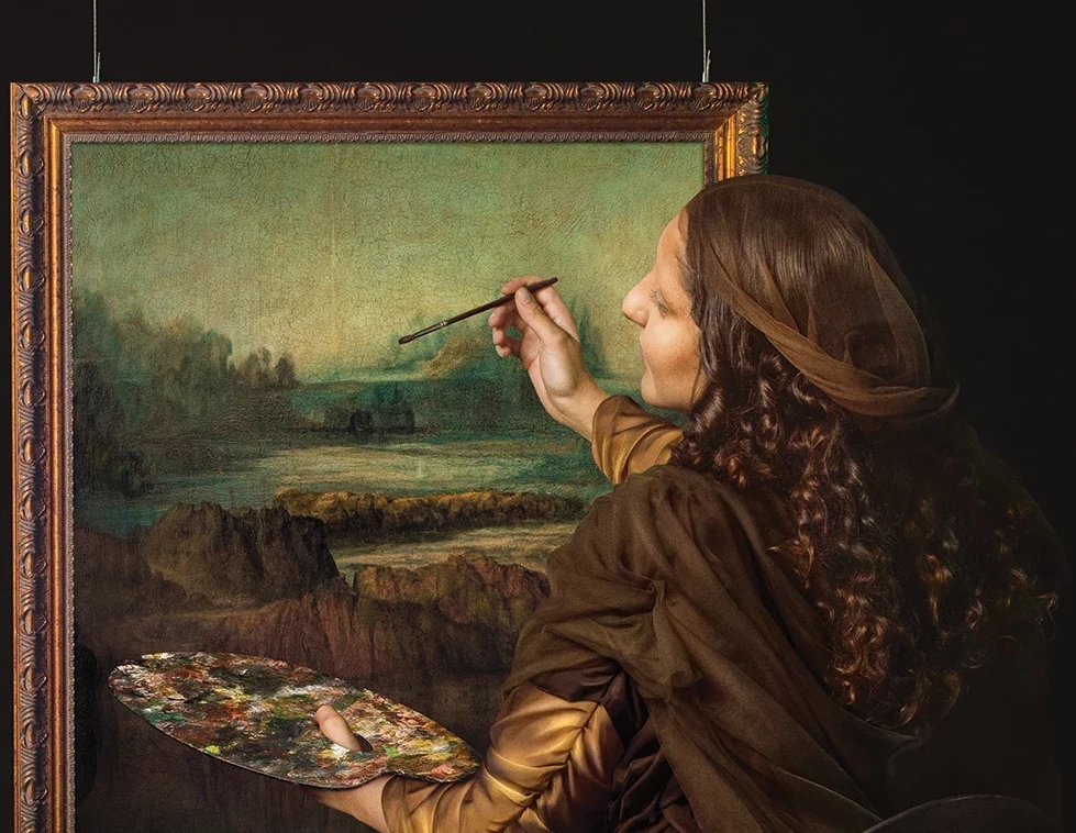 Campaign imagery of a woman painting a landscape